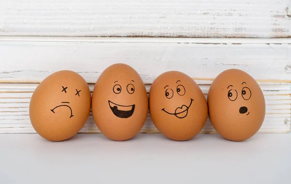 Brown eggs with cute hand drawn funny faces.