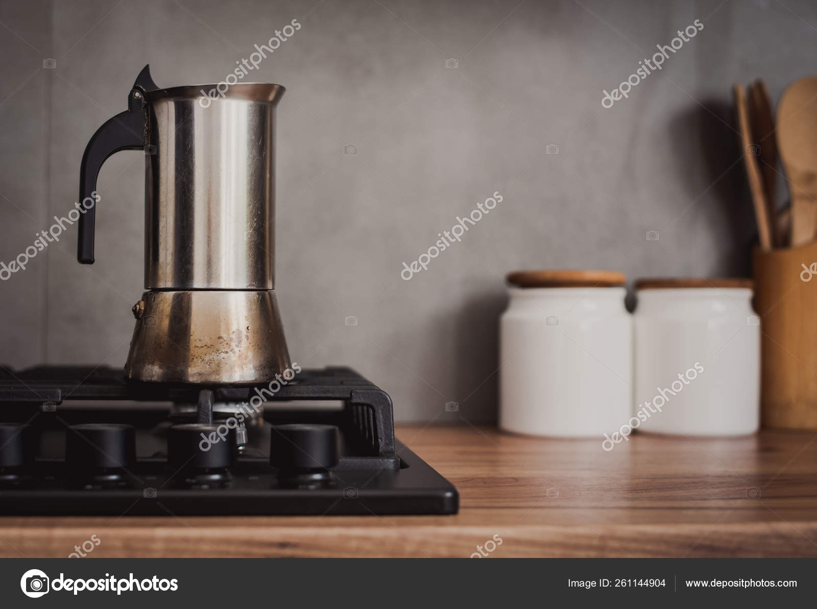Classic Italian style moka coffee pot on the gas stove with fire