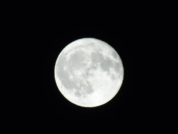 Amazing full moon over the city of Genova in winter days, with an incredible black and clear sky