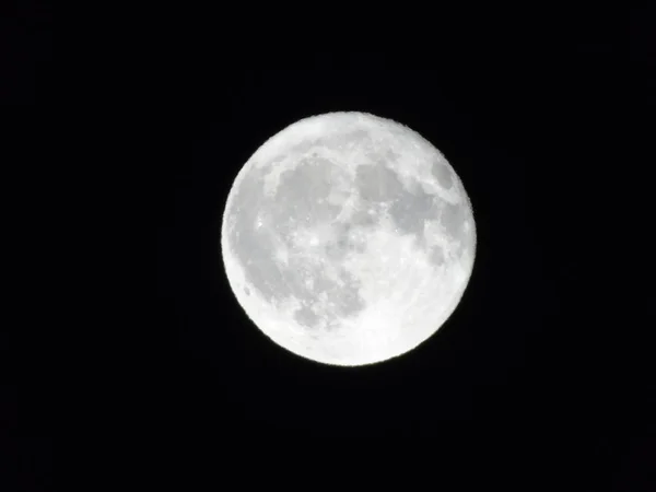 Amazing full moon over the city of Genova in winter days, with an incredible black and clear sky