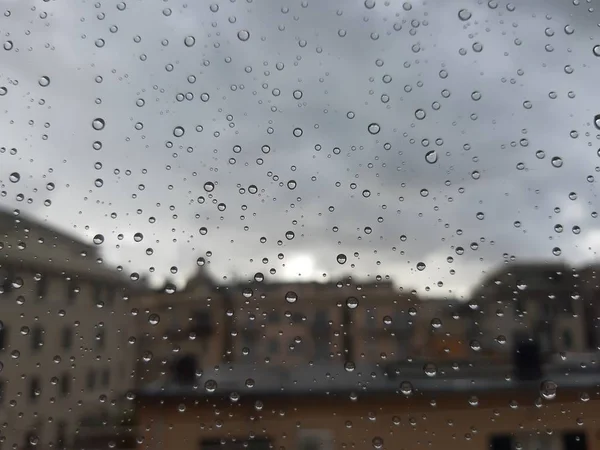 Rome, Italy - 04/12/2018: Amazing caption of the waterdrop effect over the window after a strong rain in spring days