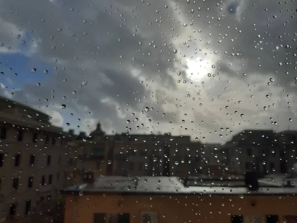 Rome, Italy - 04/12/2018: Amazing caption of the waterdrop effect over the window after a strong rain in spring days