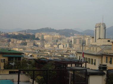Genova, Italya-04/02/2019: büyük bir gri gökyüzü, bazı uzun gökdelenler ve güzel eski binalar ile, kış günlerinde tepelerden Genova kentinin inanılmaz bir başlık