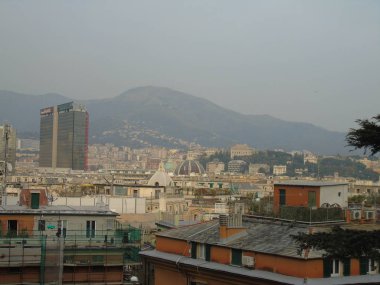 Genova, Italya-04/02/2019: büyük bir gri gökyüzü, bazı uzun gökdelenler ve güzel eski binalar ile, kış günlerinde tepelerden Genova kentinin inanılmaz bir başlık