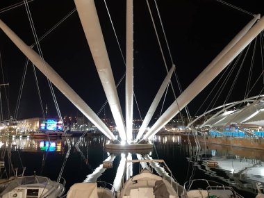 Genova, Italya-04/07/2019: bahar günlerinde gece Genova limanının inanılmaz bir başlık. Gece zevk bazı insanlar ile sahil üzerinde modern yapının güzel vieews.