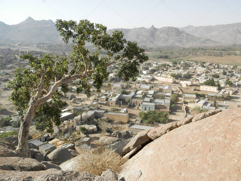 Segheneiti, Eritrea - 04/15/2019: Travelling around the vilages near Asmara and Massawa. An amazing caption of the trees, mountains and some old typical houses with very hot climate in Eritrea.