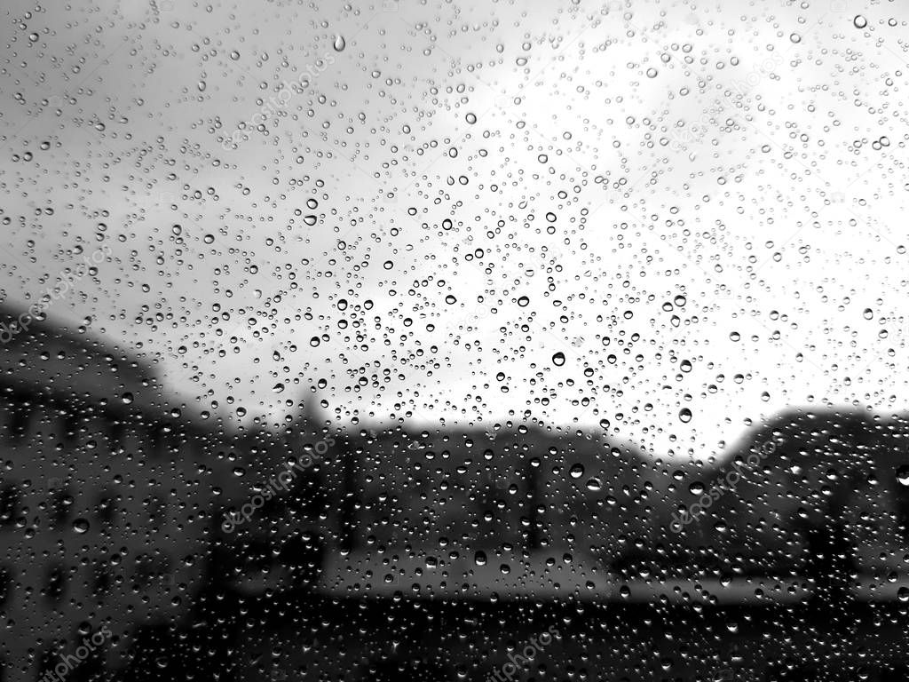 An amazing photography of some waterdrops over the window after summer rain in the city