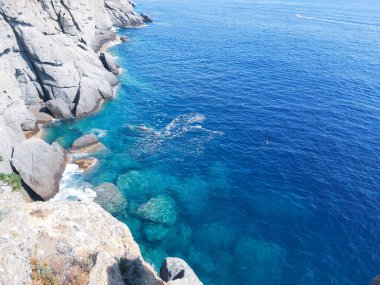 Liguria, İtalya - 05 / 31 / 2020: Liguria, İtalya, Avrupa kıyılarında büyük dalgaların kopması. Denizin beyaz dalgaları kayalıklarda kopuyor.