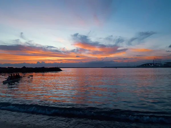 Genova, Italy - 06/18/2020: Beautiful photography of the sunset over the sea and clouds reflection on the water. Panoramic view to the ligurian coast in spring days.