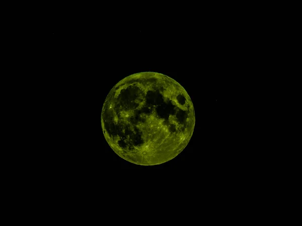 Genova, Italy - 07/07/2020: An amazing photography of the full moon over the city of Genova by night with a great clear and blue sky in the background and some stars.