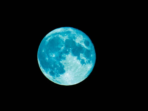 Genova, Italy - 07/07/2020: An amazing photography of the full moon over the city of Genova by night with a great clear and blue sky in the background and some stars.