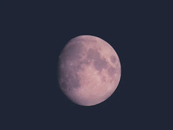 Liguria, Italy - 07/22/2020: Beautiful photography of the moonlight in the different phases with different colours. Black sky and little stars in the background.