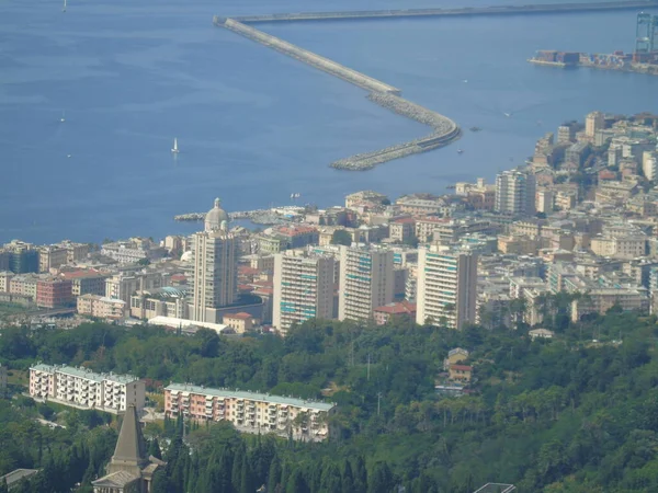 Genova, Italy  07/30/2020: Beautiful scenic aerial view of the city, port, dam, sea, Cristoforo Colombo airport runway, containers shipping terminal, Pra, Voltri, and Sestri promontory from Monte Gazzo