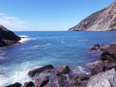 Cinque Terre, İtalya - 09 / 02 / 2020: Bir kıyı balıkçı köyünün güzel manzarası, pek çok küçük renkli ev manzarası, Cinque Terre adlı küçük İtalyan kasabasının geleneksel mimarisi