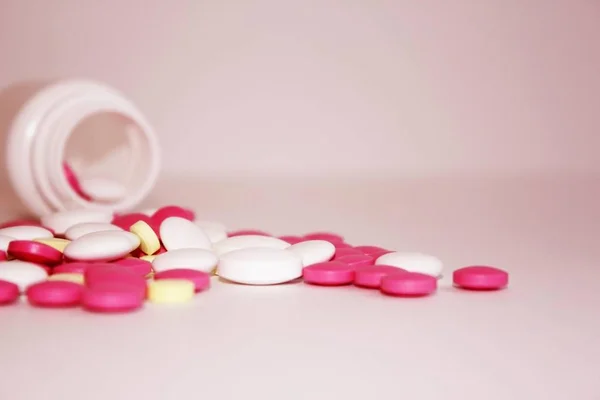 drugs tablets and vitamins scattered near plan