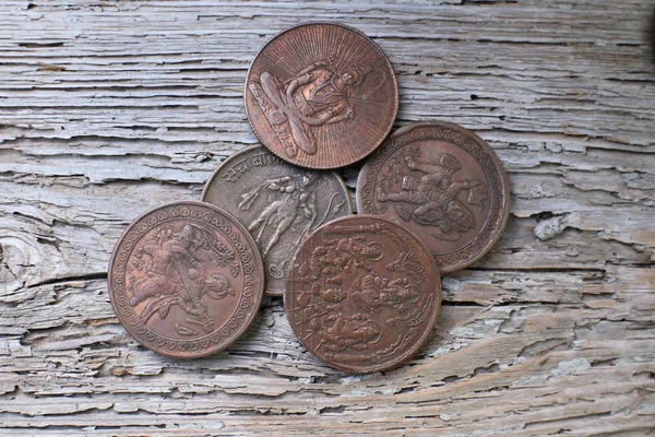 Ancient Indian copper coins on wood background
