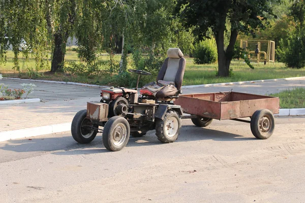 Old Chinese mini tractor with trailer