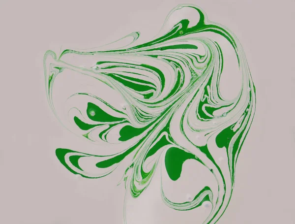 Stains of green paint on a beige background. Drops of green paint are mixed in beige paint.