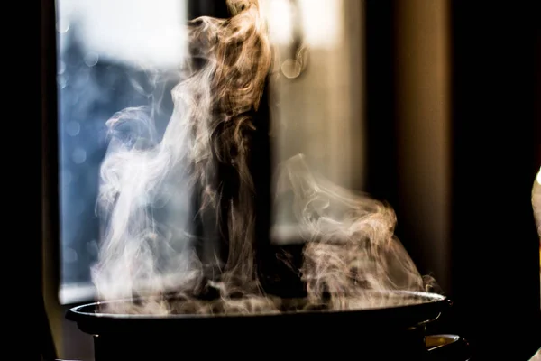 steam from the pan in the kitchen