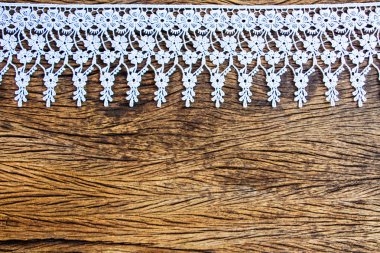 Lace on old wood table clipart