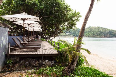 Güneş şemsiyeleri ve sandalyeler