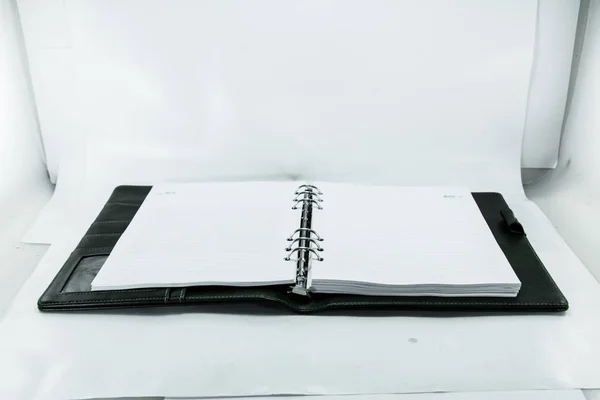 Opened paper spiral notebook on white