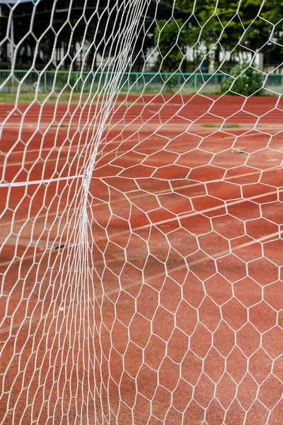 red covered stadium racetrack floor and goal net