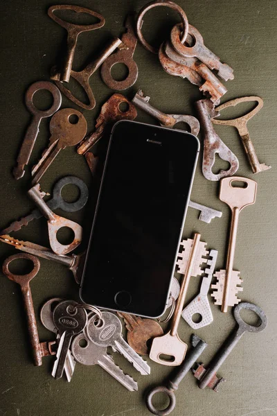 antique iron rusty keys and mobile phone