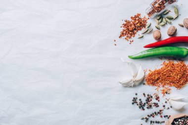 top view of scattered spices on white table clipart