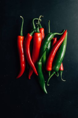 top view of red and green chili peppers on table clipart