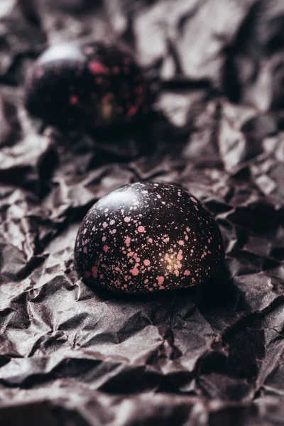 Closeup View Two Chocolate Candies Pink Splashes Crumpled Paper — Free Stock Photo