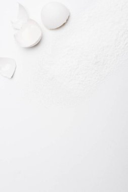 Kırık yumurta kabukları dökülmüş un ile üstten görünüm beyaz yüzeyi