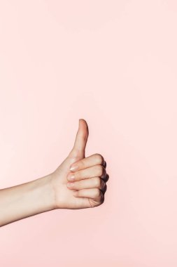  cropped image of woman doing thumb up gesture isolated on pink background clipart