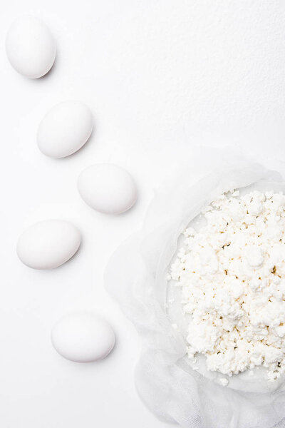 top view of cottage cheese and eggs on white surface