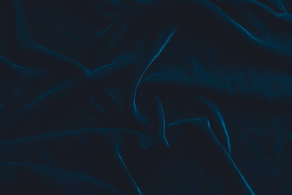 Luxurious dark blue velvet fabric background 