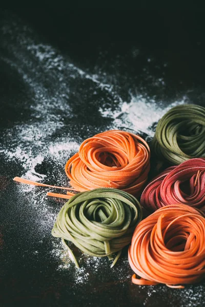 Closeup View Raw Colorful Tagliatelle Pasta Table Covered Flour — Stock Photo, Image