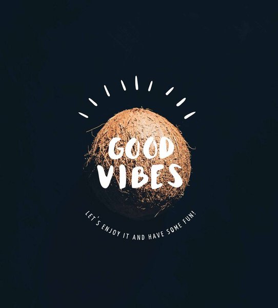 close-up view of single whole ripe coconut isolated on black with "good vibes" inspection 