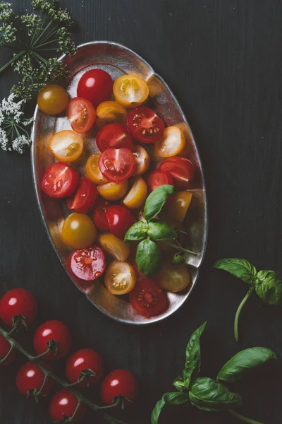 Top view of cutted red and yellow cherry tomatoes in metal plate with basil leaves — Stock Image Top View Cutted Red Yellow Cherry Tomatoes Metal Plate Basil Royalty Free Stock Photos