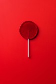 top view of one lollipop on red surface