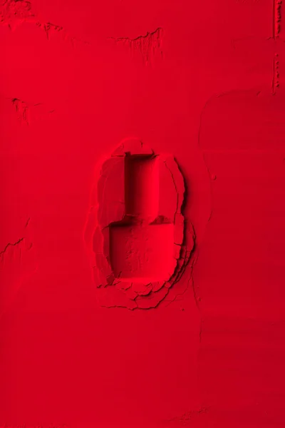 top view of shape of nail polish bottle on red powder