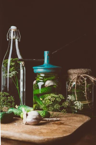 Glass jars with preserved cucumbers and dill with garlic on table — Stock Image Glass Jars Preserved Cucumbers Dill Garlic Table Stock Image