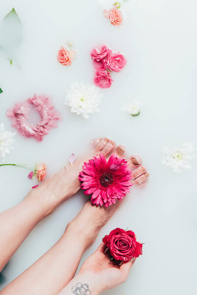Partial view of woman and beautiful colorful flowers in milk — Stock Image Partial View Woman Beautiful Colorful Flowers Milk Stock Photo