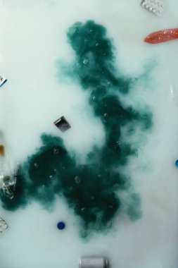 top view of smoke and garbage flowing in water, environment protection concept