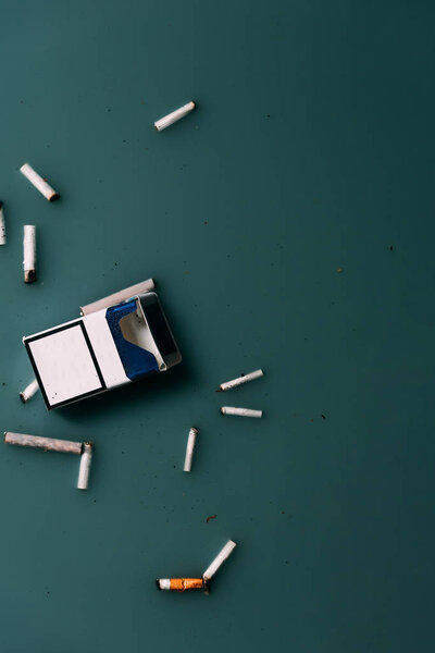 top view of cigarettes and package flowing in water, ecology protection concept