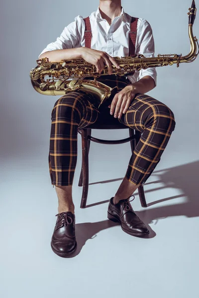 Cropped Shot Stylish Professional Musician Sitting Saxophone Grey — Free Stock Photo