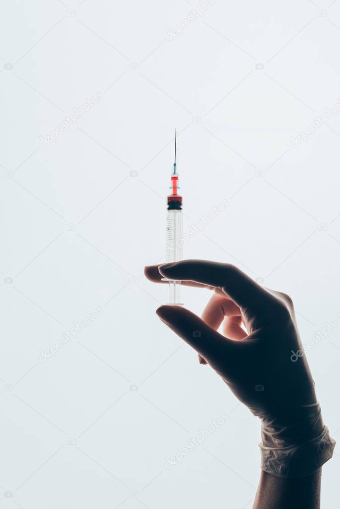 cropped shot of doctor holding syringe isolated on white