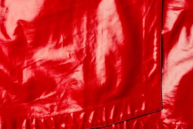 elevated view of red leather shiny textile as background 