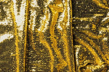 top view of golden textile with shiny sequins as background  clipart