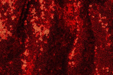 top view of dark red textile with shiny sequins as background  clipart