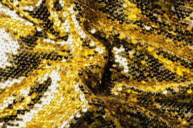 top view of yellow textile with shiny sequins as background  clipart